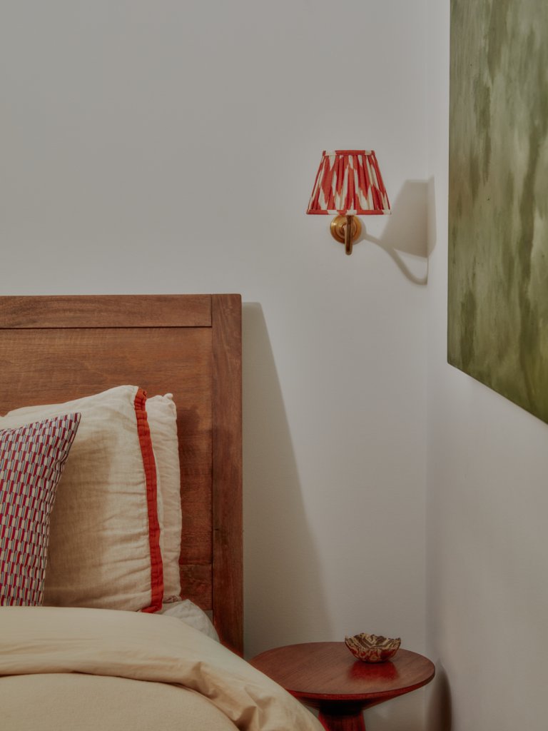 sconce next to wood bed